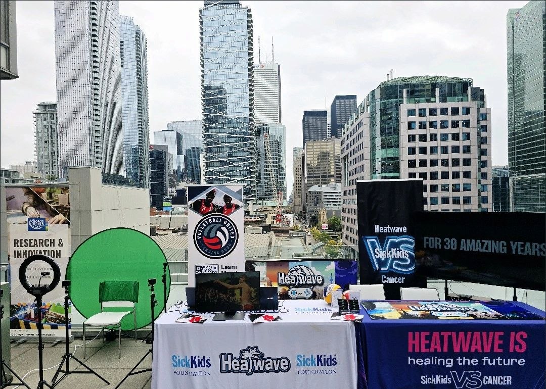 Valente Productions - Heatwave Volleyball and SickKids Foundation booth on the Toronto rooftop at the Trend Hunter Future Festival 2024, with green screen and Volleyball United signage
