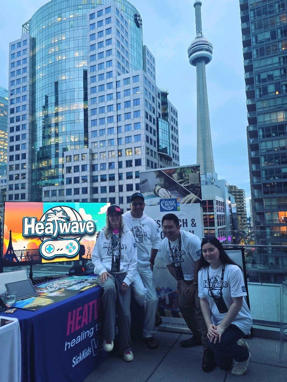 Valente Productions - Heatwave Volleyball and George Brown research team at the Trend Hunter Future Festival booth at dusk, CN Tower behind, Toronto 2024